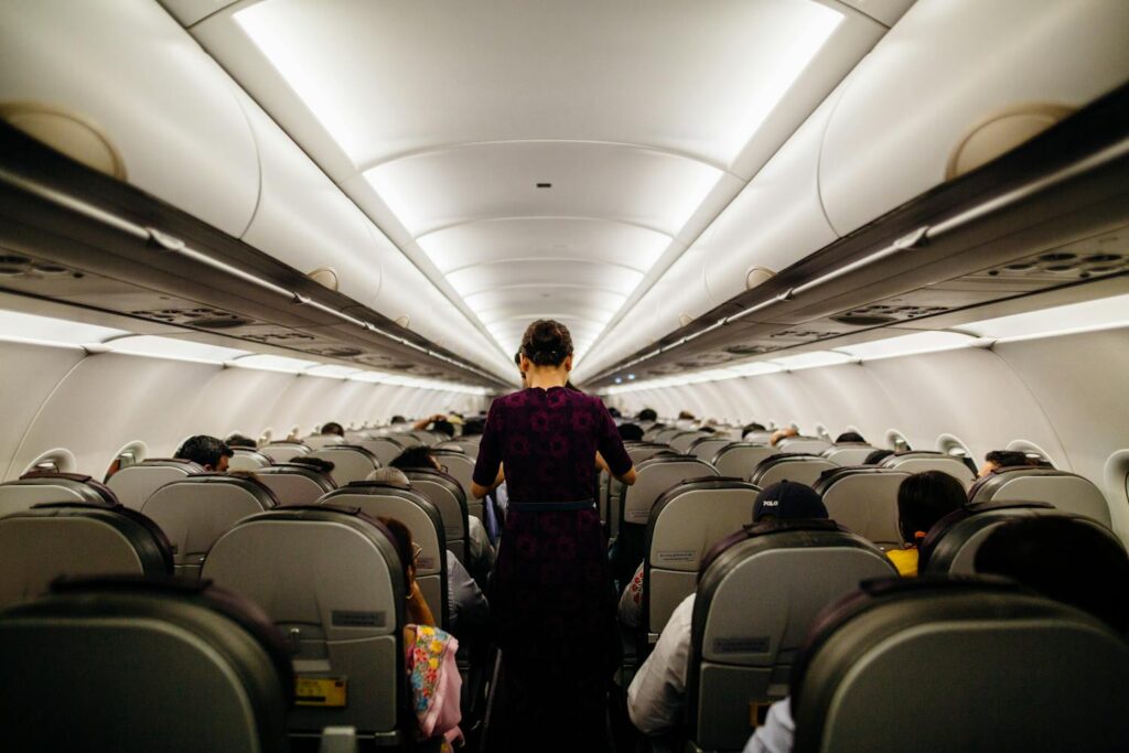Flight attendant in the airplane aisle